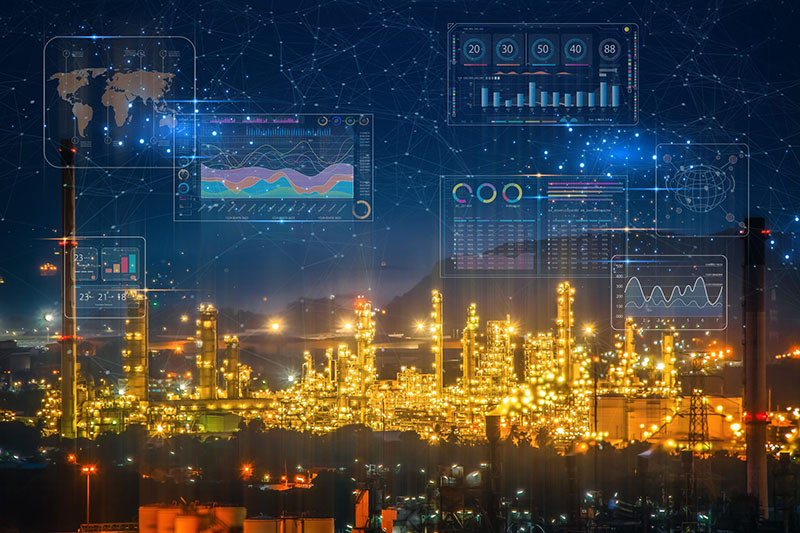 A brightly lit industrial refinery at night with digital data graphs and charts overlayed, symbolizing industrial technology, data analysis, and advanced monitoring systems in a connected, modern facility.